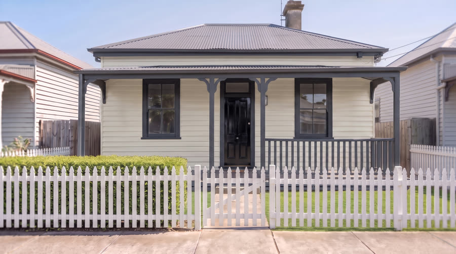 A house exterior painted in a warm antique white